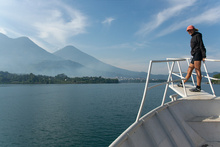 Dasa on the ferry with volcanoes in the background