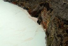 Blue color of the acid lake inside the crater